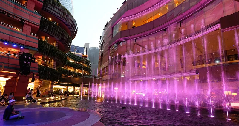 Colourful illuminated fountains between the curving buildings of Canal City Hakata