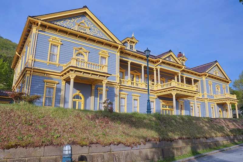 The blue-and-yellow facade of the Old Public Hall of Hakodate Ward
