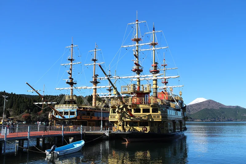 Queen Ashinoko and Victory sightseeing ships at Hakonemachi Port, with Lake Ashi and Mount Fuji beyond