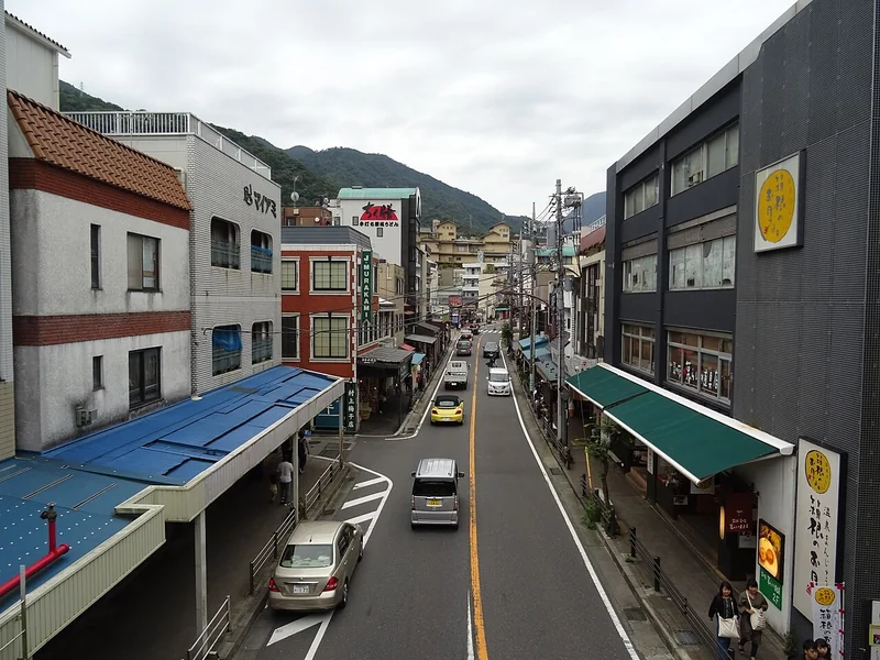 The main shopping street at Hakone-Yumoto, with shops and mountain slopes beyond