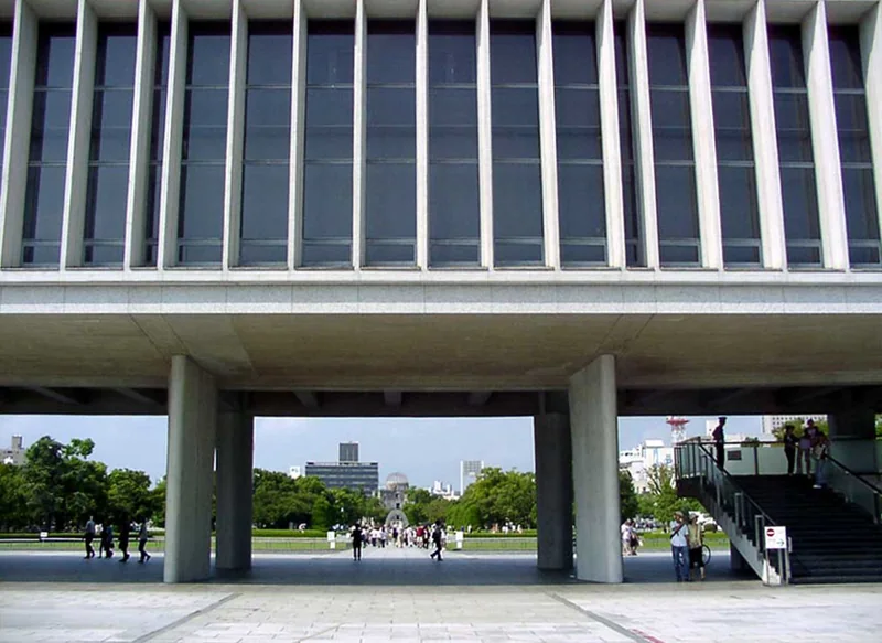 The raised facade of Hiroshima Peace Memorial Museum framing a view through to the park