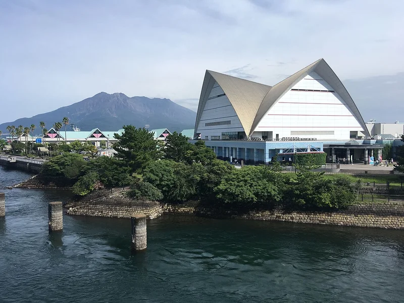 Kagoshima Aquarium beside the water with Sakurajima in the distance