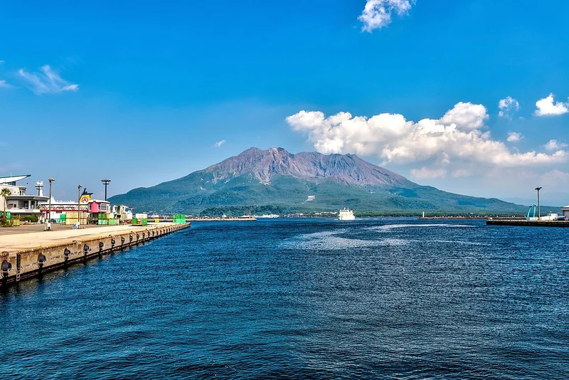 Sakurajima and the blue waters of Kagoshima Bay viewed from Waterfront Park
