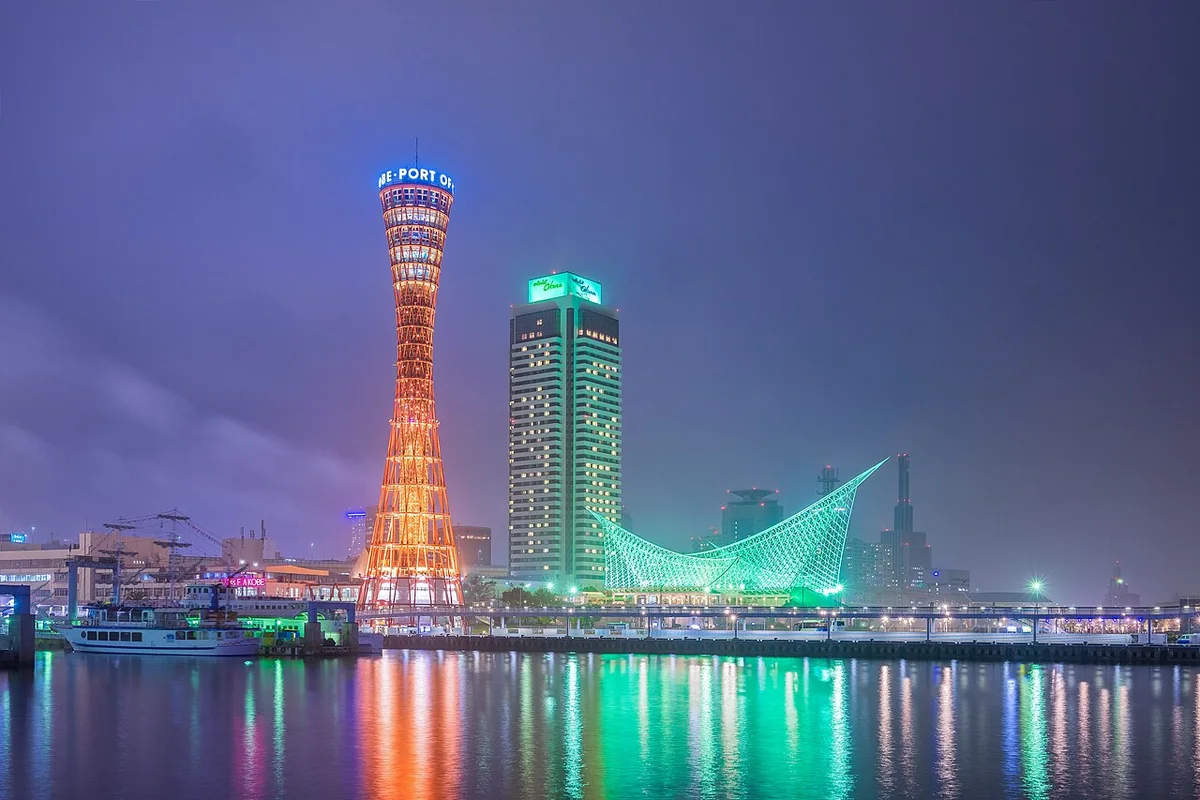 Kobe Port Tower and the Maritime Museum reflected in the water, seen from Harborland at twilight
