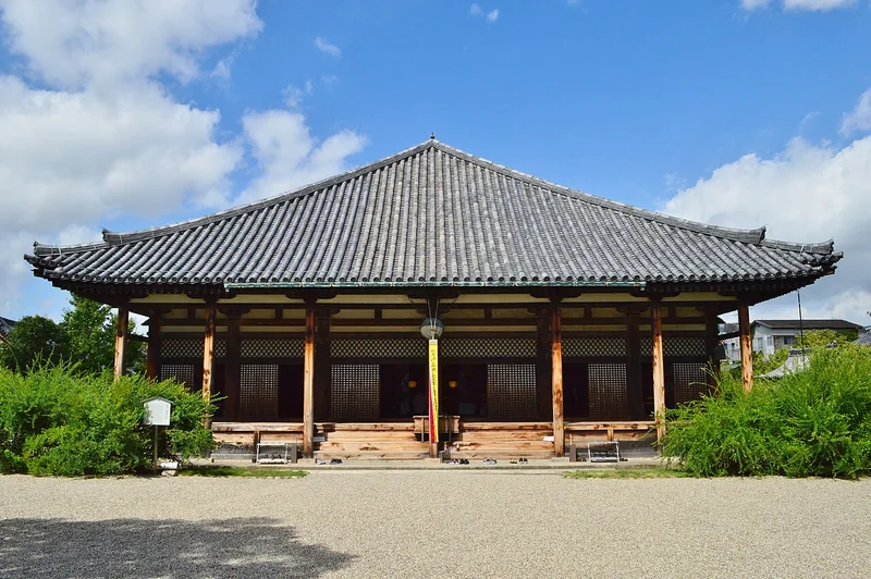 The tiled roof and wooden facade of the main hall at Gangoji