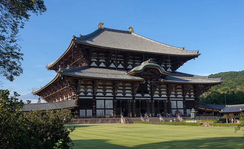 The Great Buddha Hall at Todaiji, framed by trees beneath a blue sky