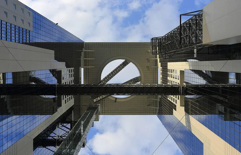 Looking up through Umeda Sky Building toward its circular rooftop opening
