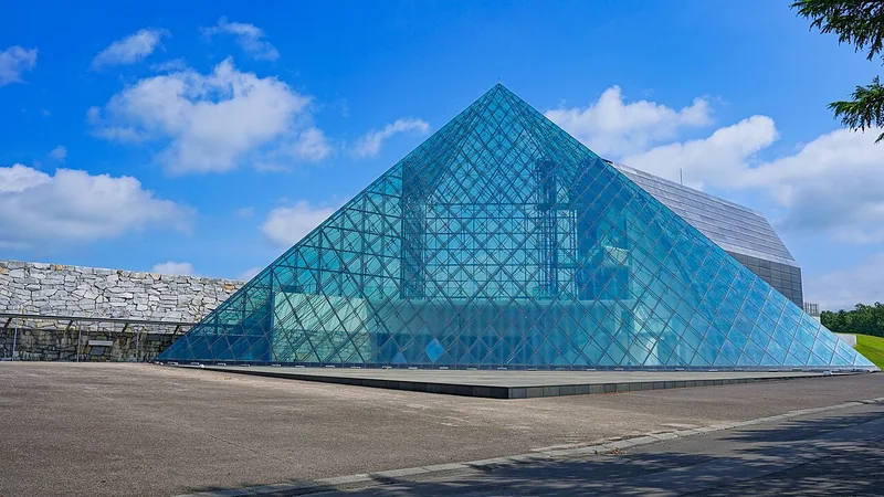 The glass pyramid at Moerenuma Park beneath a blue sky