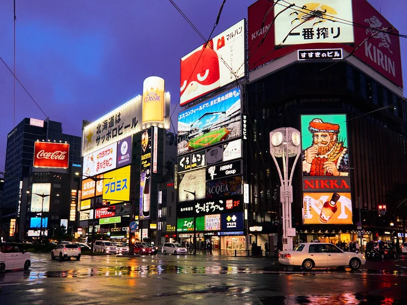 Bright signs and evening lights at the Susukino intersection