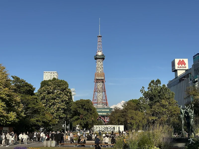 Sapporo TV Tower above the trees and paths of Odori Park