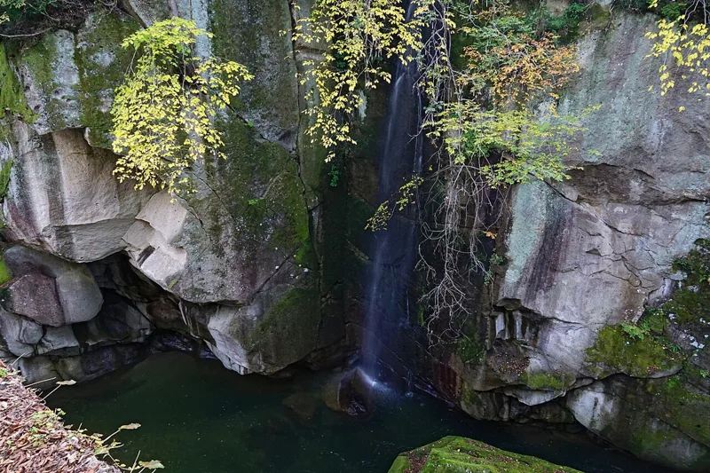 Water falling between rock walls at Rairaikyo Gorge