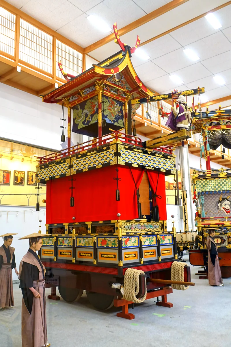 An ornate festival float inside Takayama Festival Floats Exhibition Hall