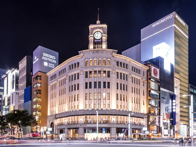 The illuminated Wako clock tower and department stores at the Ginza crossing