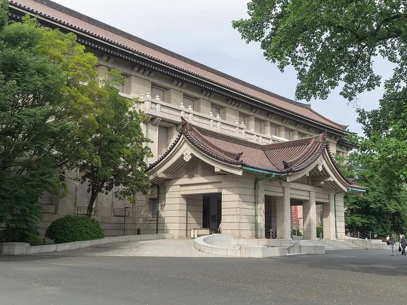 The Honkan main building of Tokyo National Museum framed by leafy trees