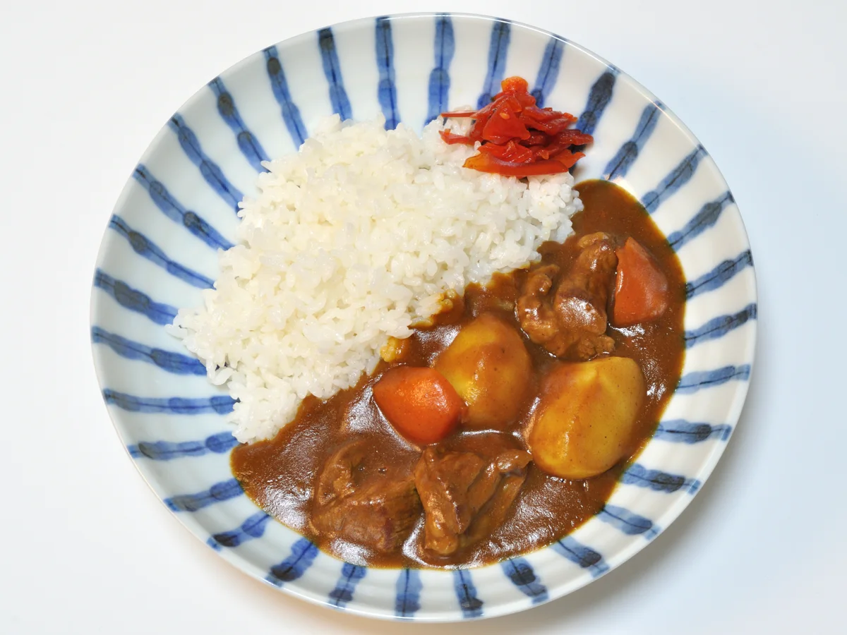 Beef curry with rice, potato, carrot and onion.
