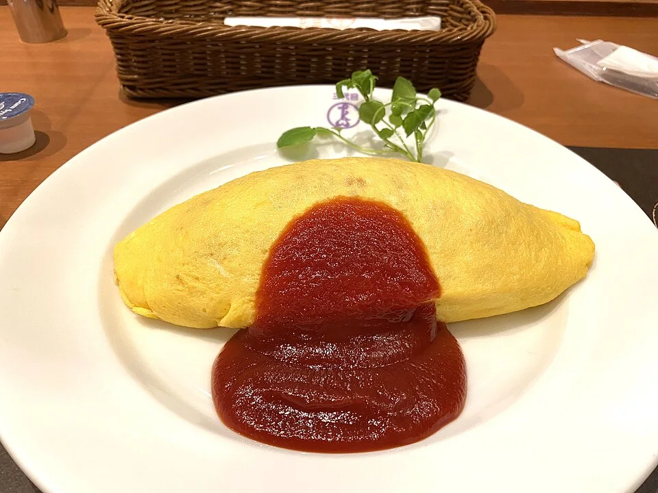 Omurice, an omelette over seasoned rice with tomato sauce.