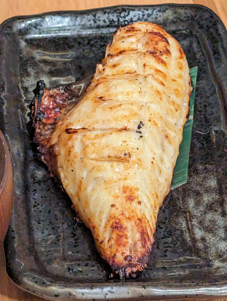 A split, grilled hokke fish.