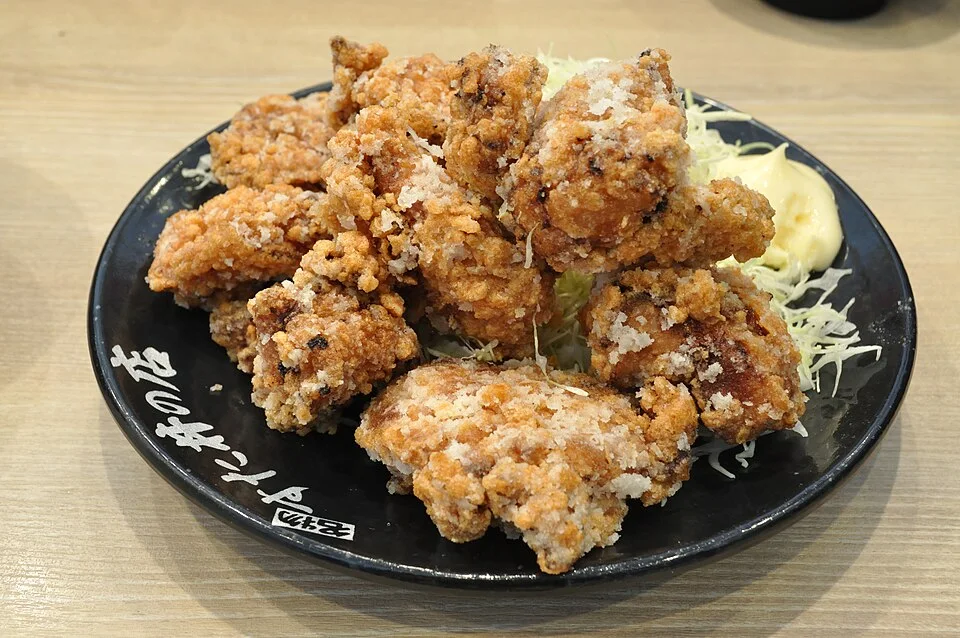 A generous plate of chicken karaage with shredded cabbage.