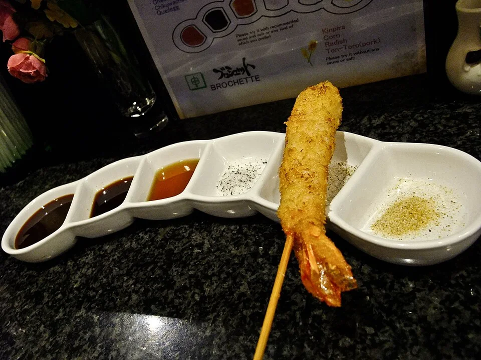 Fried skewers with dipping sauces.