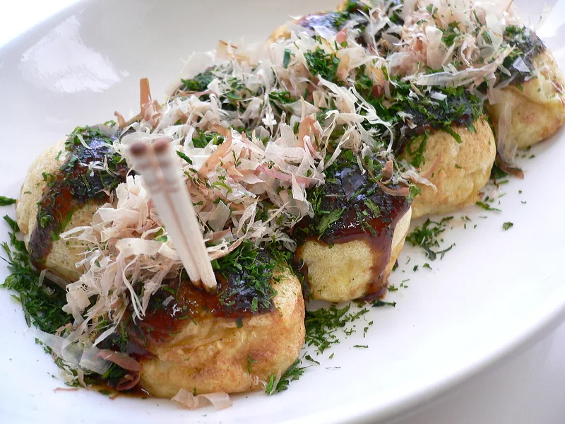 Takoyaki with sauce, seaweed and bonito-flake toppings.
