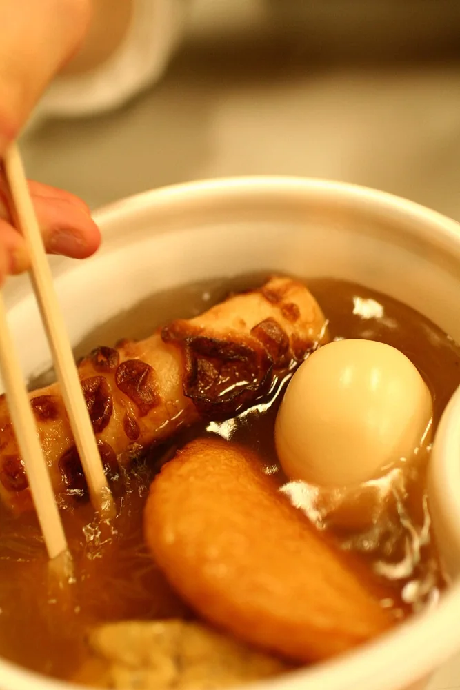 Assorted oden ingredients simmering in broth.