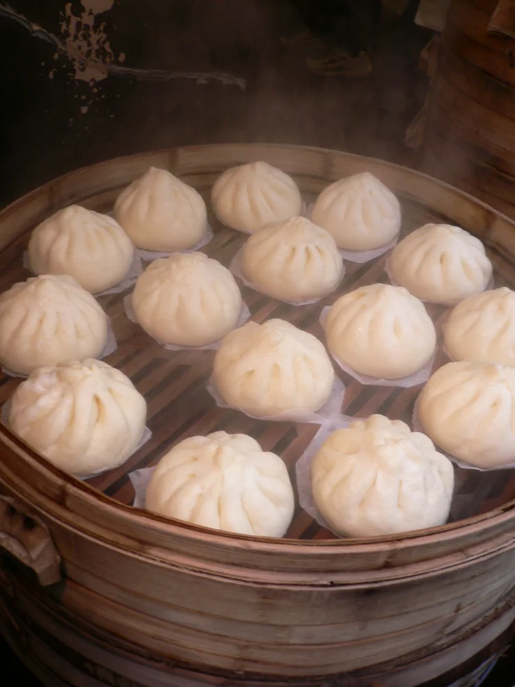 Nikuman meat buns in a steamer.
