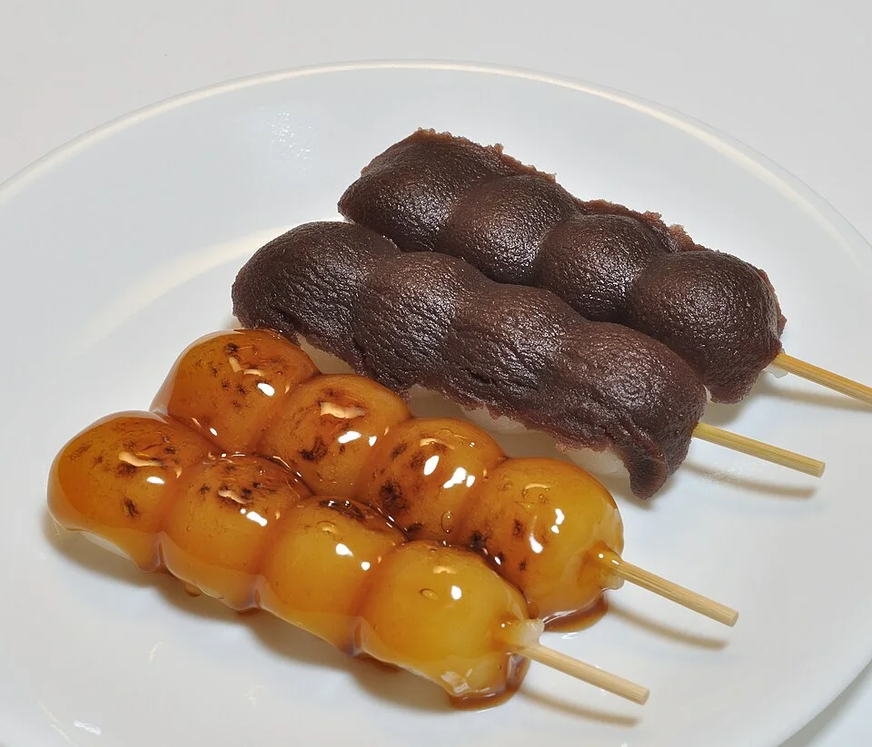 Mitarashi dango in front, with other dango skewers behind.