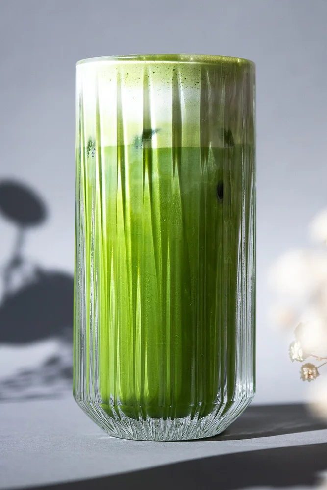 A matcha latte in a tall glass.