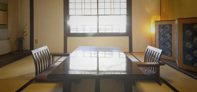 A traditional tatami guest room with a low table at Yoshii Ryokan