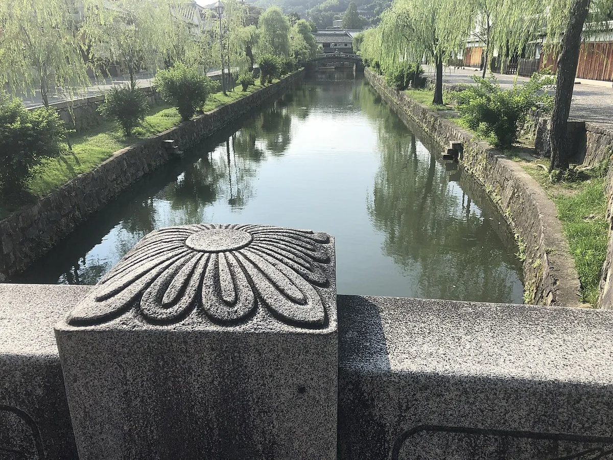 Traditional white-walled buildings beside Kurashiki’s canal