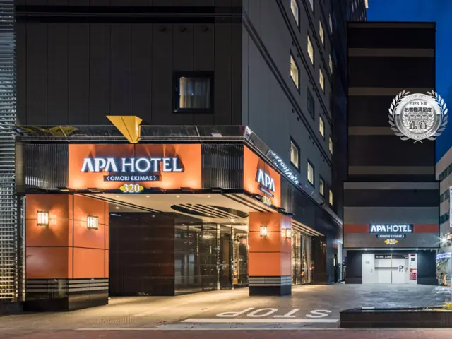 The illuminated entrance to APA Hotel Omori Ekimae