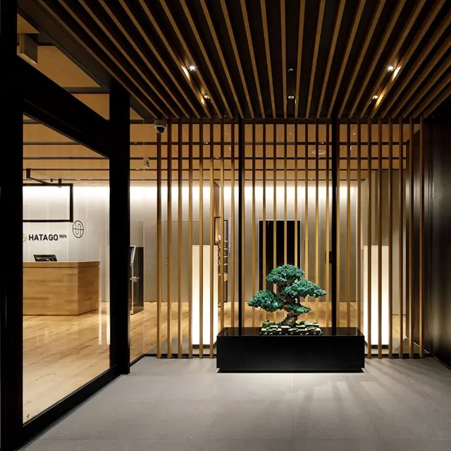 Wooden reception and bonsai display at HATAGO INN Kansai Airport