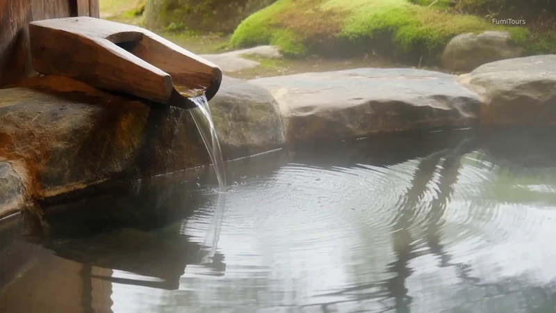 Water flowing from a bamboo spout into a quiet Japanese bath, from The Space Between