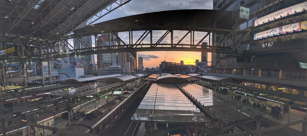 Osaka Station platforms beneath the great roof at sunset