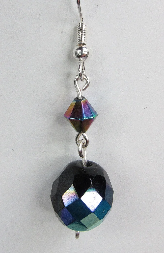 An earring with faceted beads