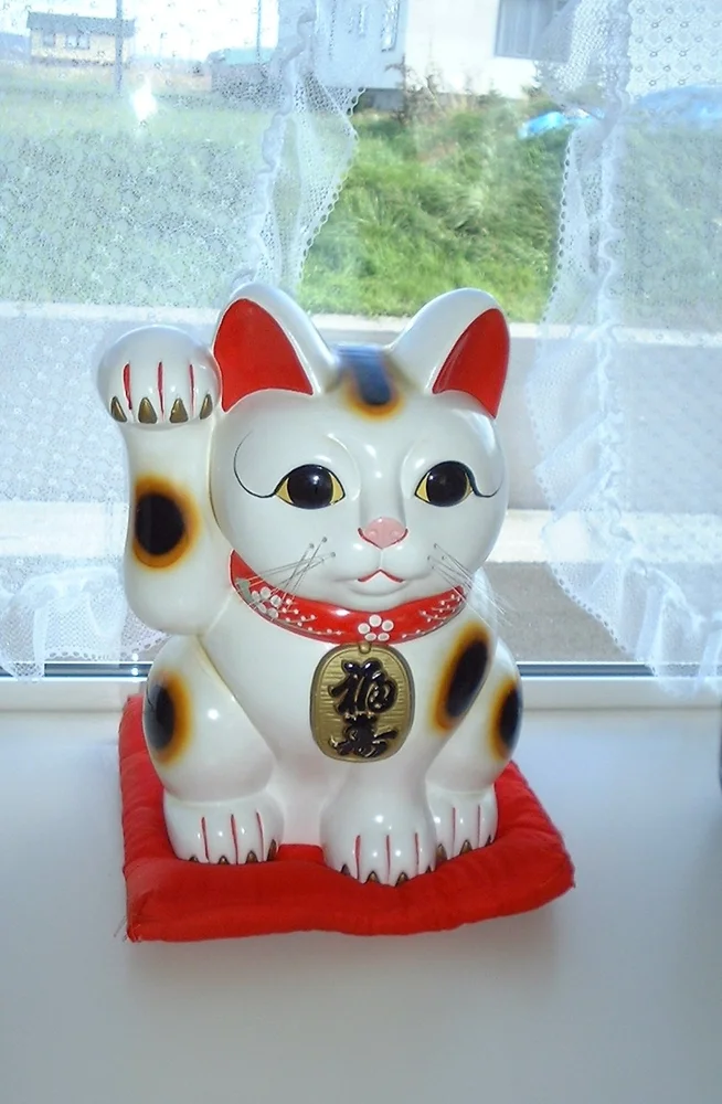 A white beckoning cat, or maneki-neko
