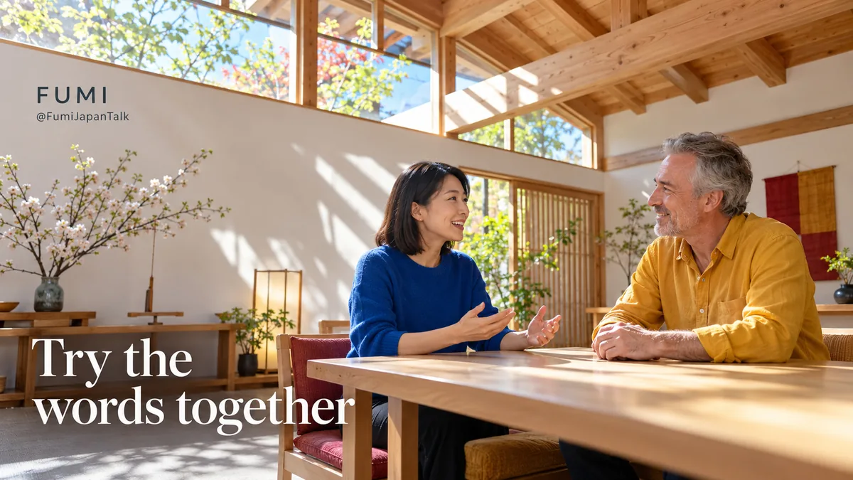 Two adults practise conversation across an oak table beneath sunlit cedar beams in a bright community room.