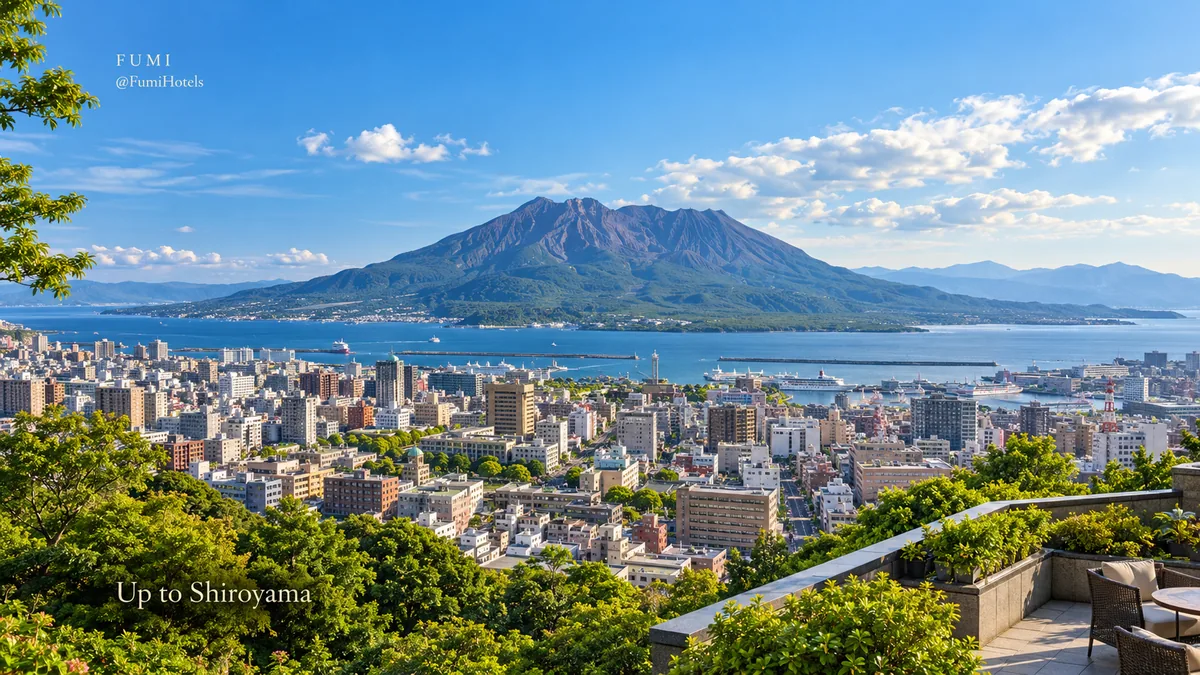 Sakurajima rises across the blue bay beyond Kagoshima and Shiroyama’s hillside.