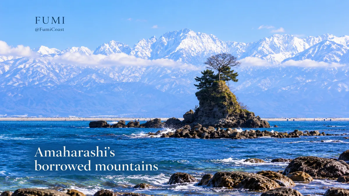 Pine-topped Onnaiwa rock against the distant snowy Tateyama range across Toyama Bay.